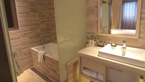 A modern bathroom with a glass-enclosed shower, a bathtub, and a vanity with a mirror. - Riverview Suites Taipei (Taipei)
