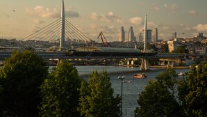 A bridge spanning a river with a cityscape in the background. - Görür Hotel (Istanbul)