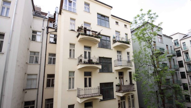 A multi-story residential building with balconies, windows, and a tree in the foreground. - Prague Central Exclusive Apartments (Prague)