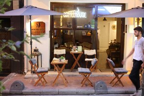A New Pera Hotel with outdoor seating and a coffeehouse sign. - New Pera (Istanbul)