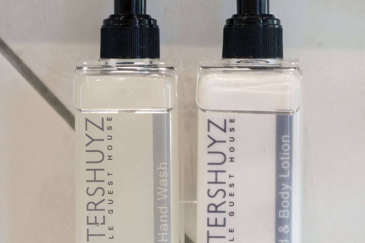 Two bottles of Richtershuyz hand wash and body lotion on a bathroom counter.