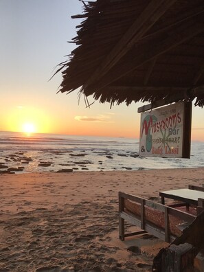 A beach scene with a sign for 'Mushrooms Bar' and 'Bang Lassi'. - Lanta Darawadee Resort (Ko Lanta)