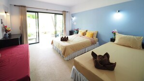 A hotel room with two beds, a desk, and a view of the outdoors. - Lanta Darawadee Resort (Ko Lanta)