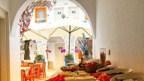 A narrow passageway with a buffet table displaying various food items and utensils. - Sade Butik Otel (Bodrum)