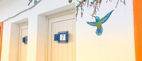 A building with two doors, each marked with a number sign.