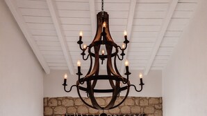 A staircase with a black railing, a stone wall, and a wooden ceiling. - Alacati Casa Bella (Cesme)