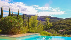 A pool with a view of a mountainous landscape and a village in the background. - Cavarchino B&B (Gaiole in Chianti)