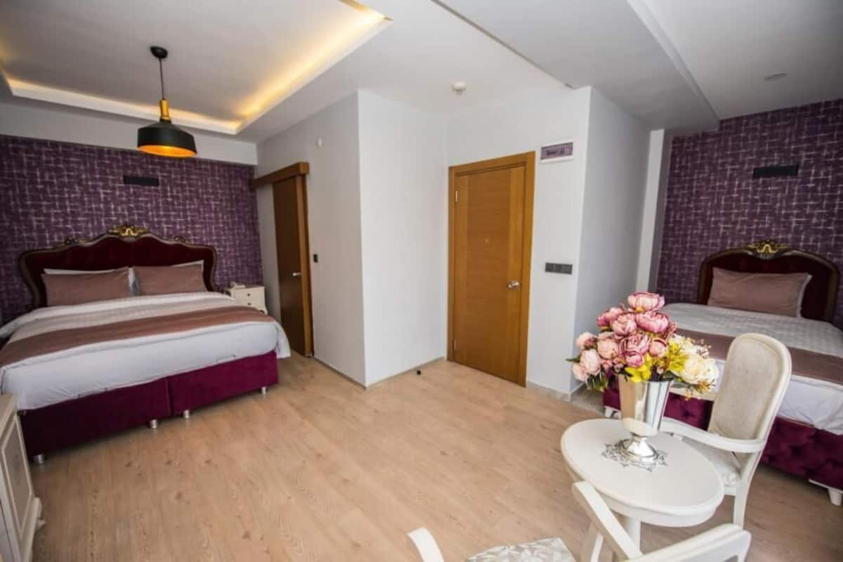 Deluxe Quadruple Room | 1 bedroom, premium bedding, in-room safe, individually furnished