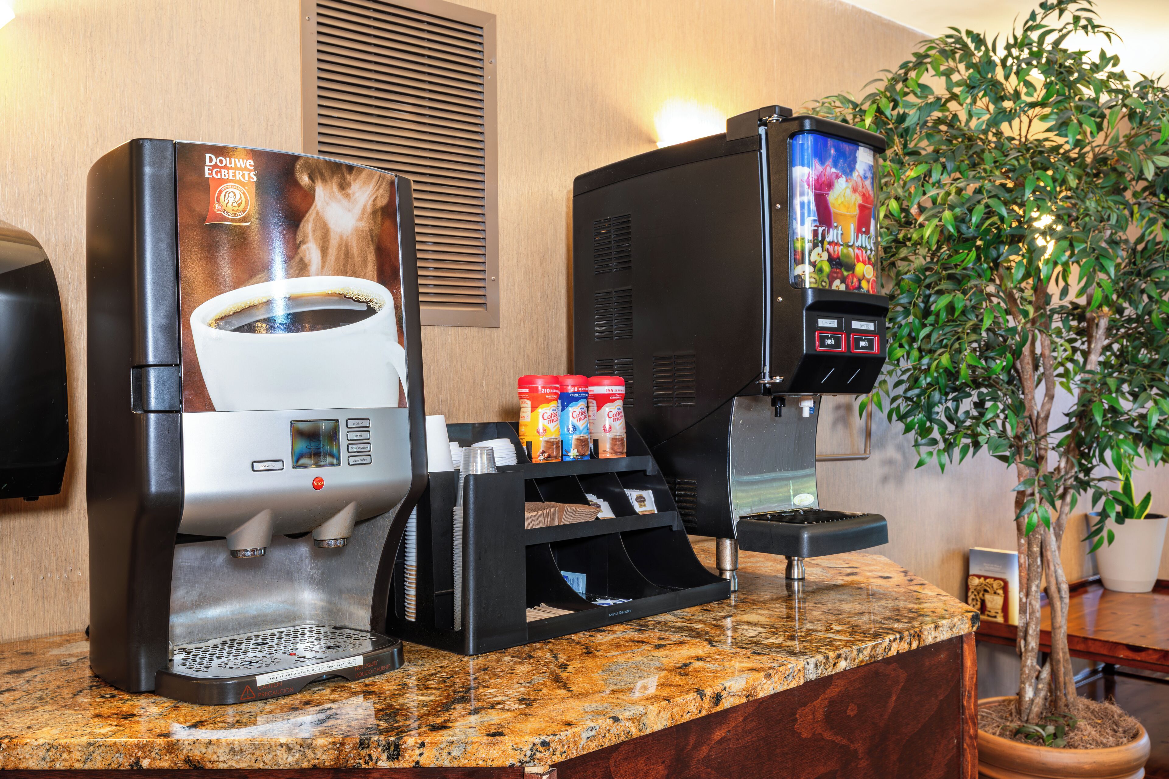 A coffee machine with a cup of coffee and a selection of coffee pods.