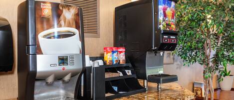 A coffee machine with a cup of coffee and a selection of coffee pods.