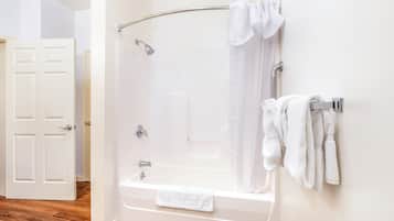 A modern bathroom with a walk-in shower, a bathtub, and a towel rack.