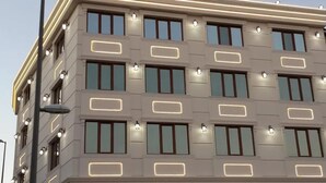 A multi-story building with a symmetrical facade, rectangular windows, and evenly spaced light fixtures. - Sahra Airport Hotel (Istanbul)