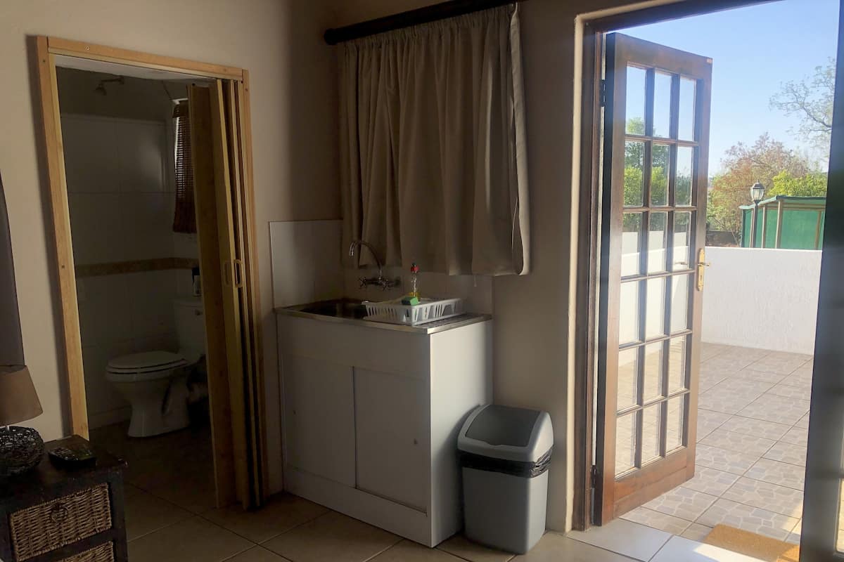 A compact bathroom with a toilet, sink, and shower.