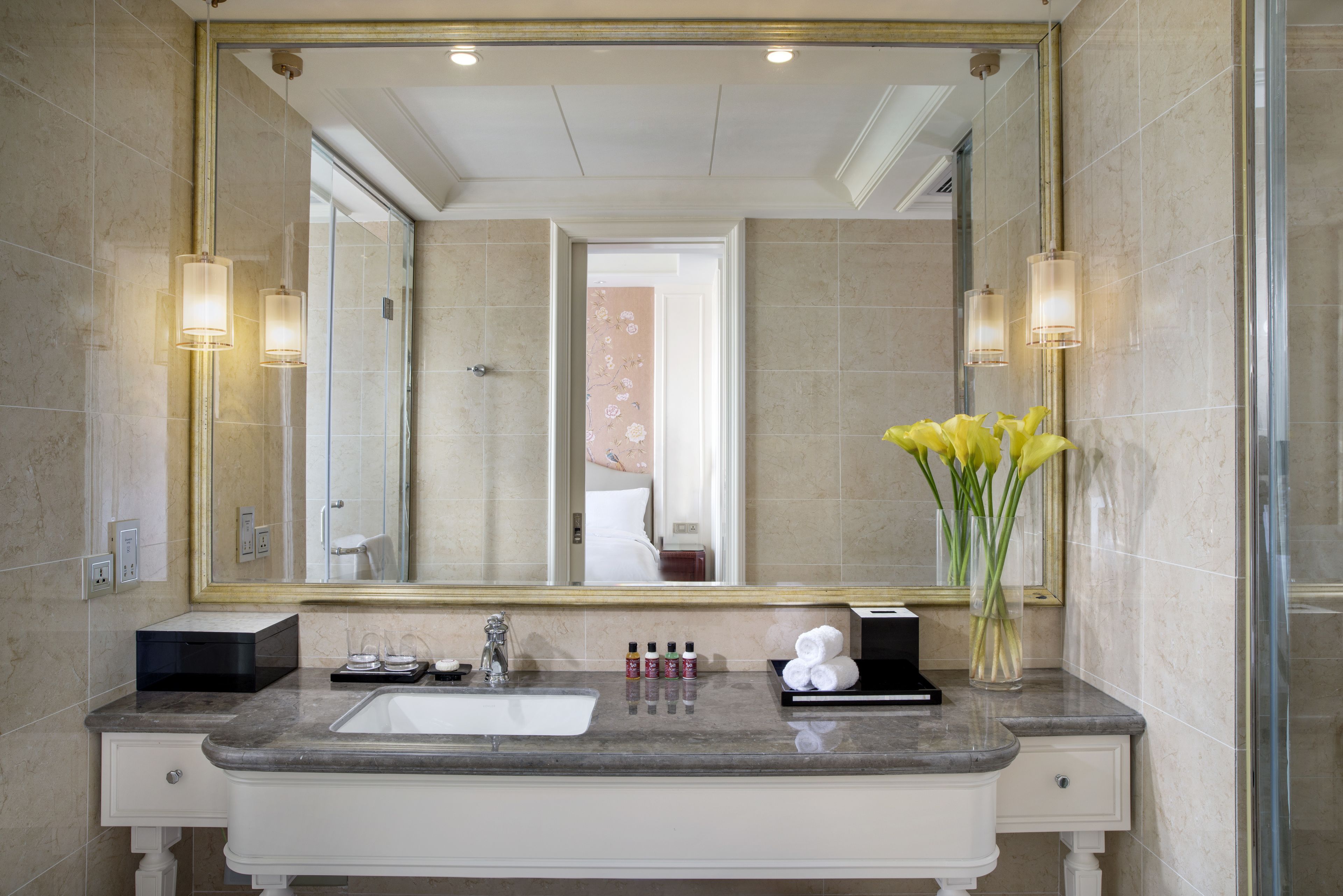 rainfall showerhead, eco-friendly toiletries, slippers, towels