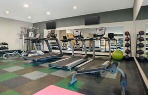 A gym with treadmills, weight machines, and a mirrored wall. - Extended Stay America Suites - Donaldsonville - Gonzales (St James)