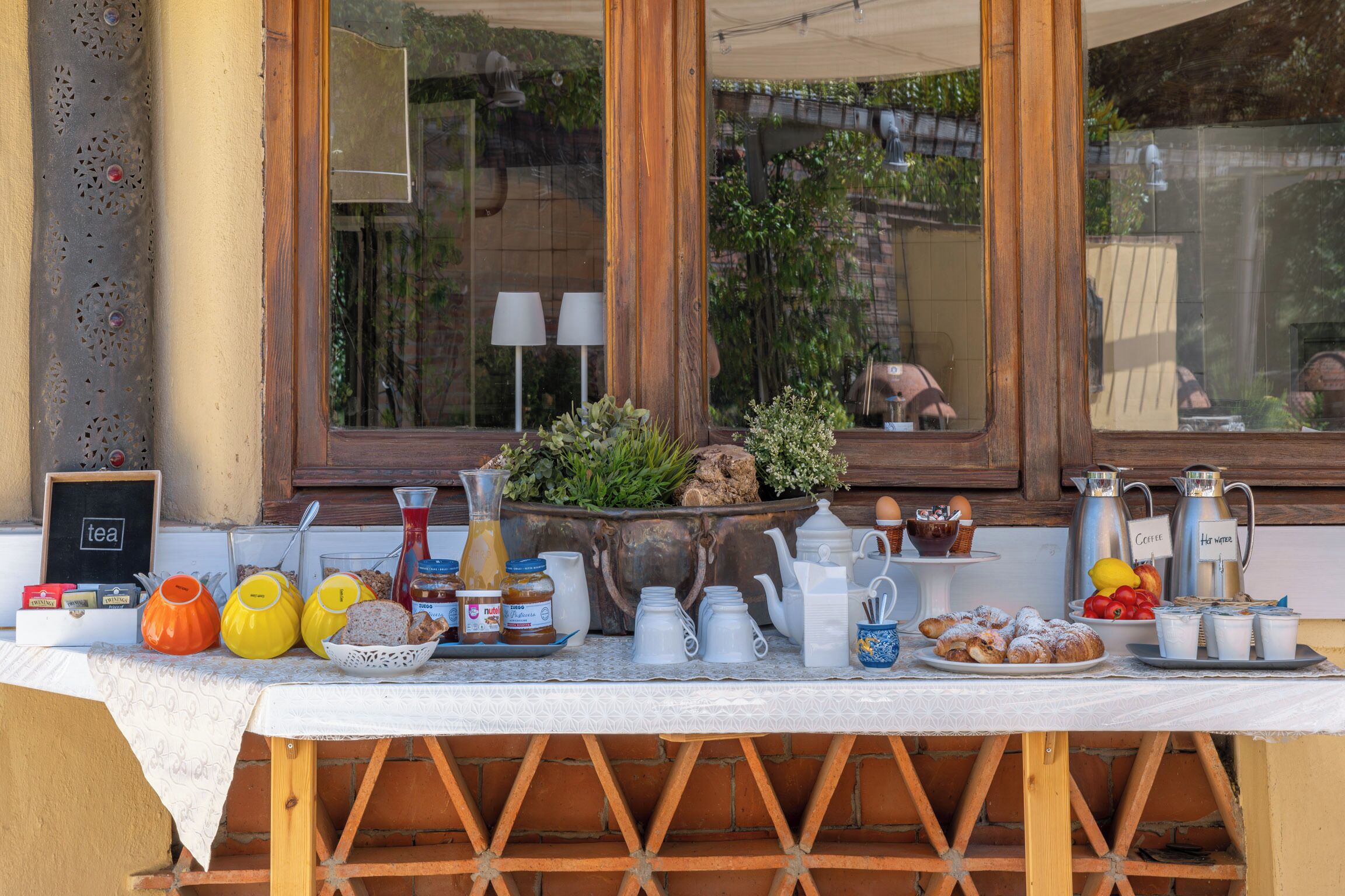 Un bufé de desayuno con diversos alimentos y bebidas sobre una mesa.