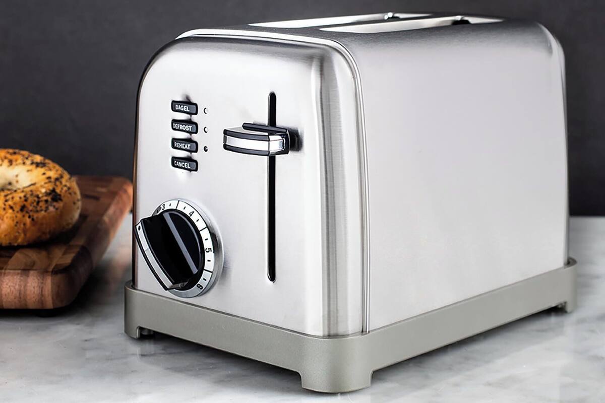 A stainless steel toaster with a digital display and control buttons.