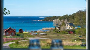 A coastal view with houses, a clear sky, and a body of water. - Utö Värdshus (Uto)