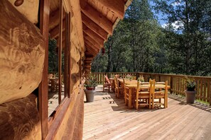 A wooden deck with outdoor seating and potted plants. - Rock Lake Lodge (Rock Lake)