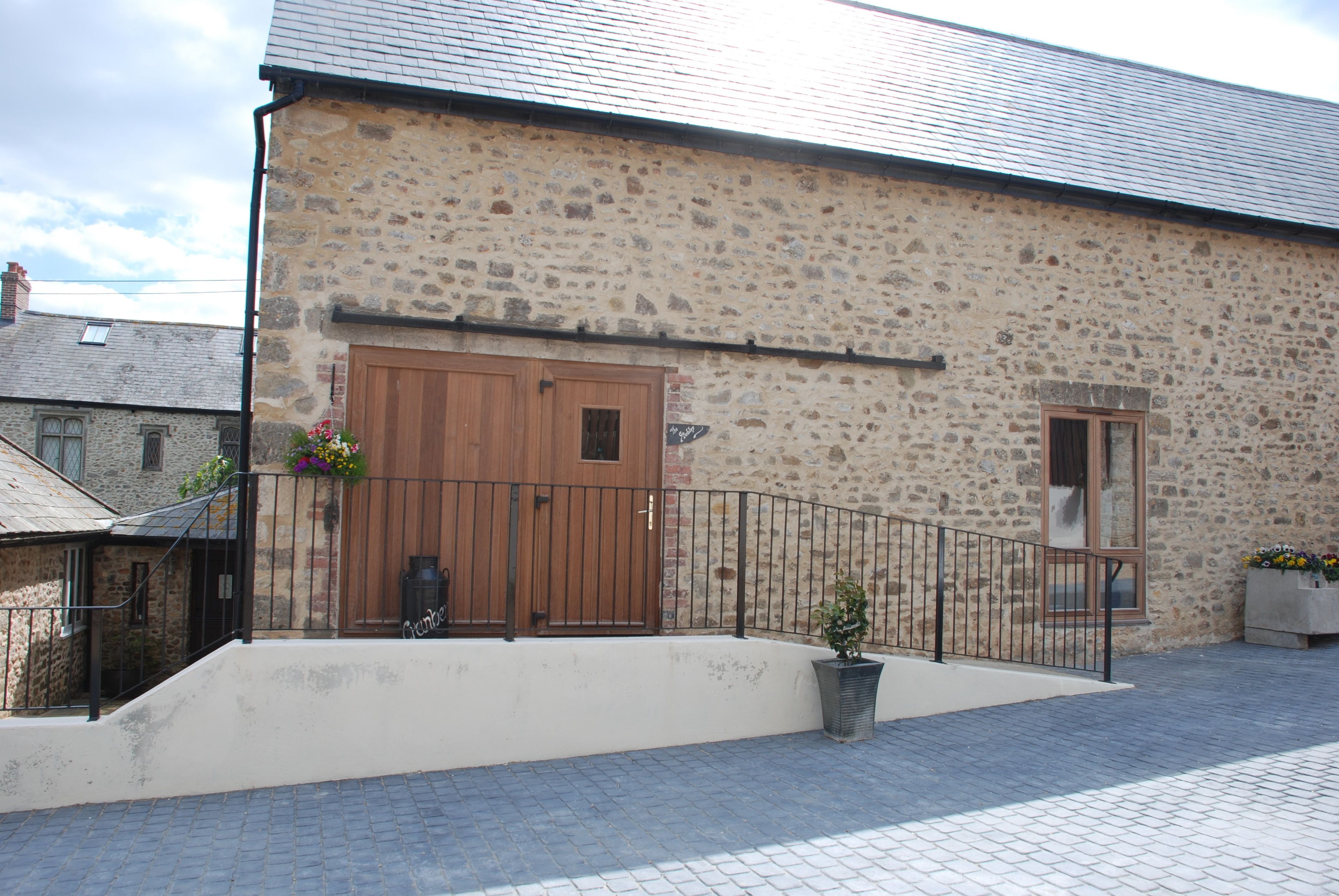 A stone building with a wooden door and a small window.