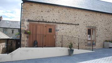 A stone building with a wooden door and a small window.