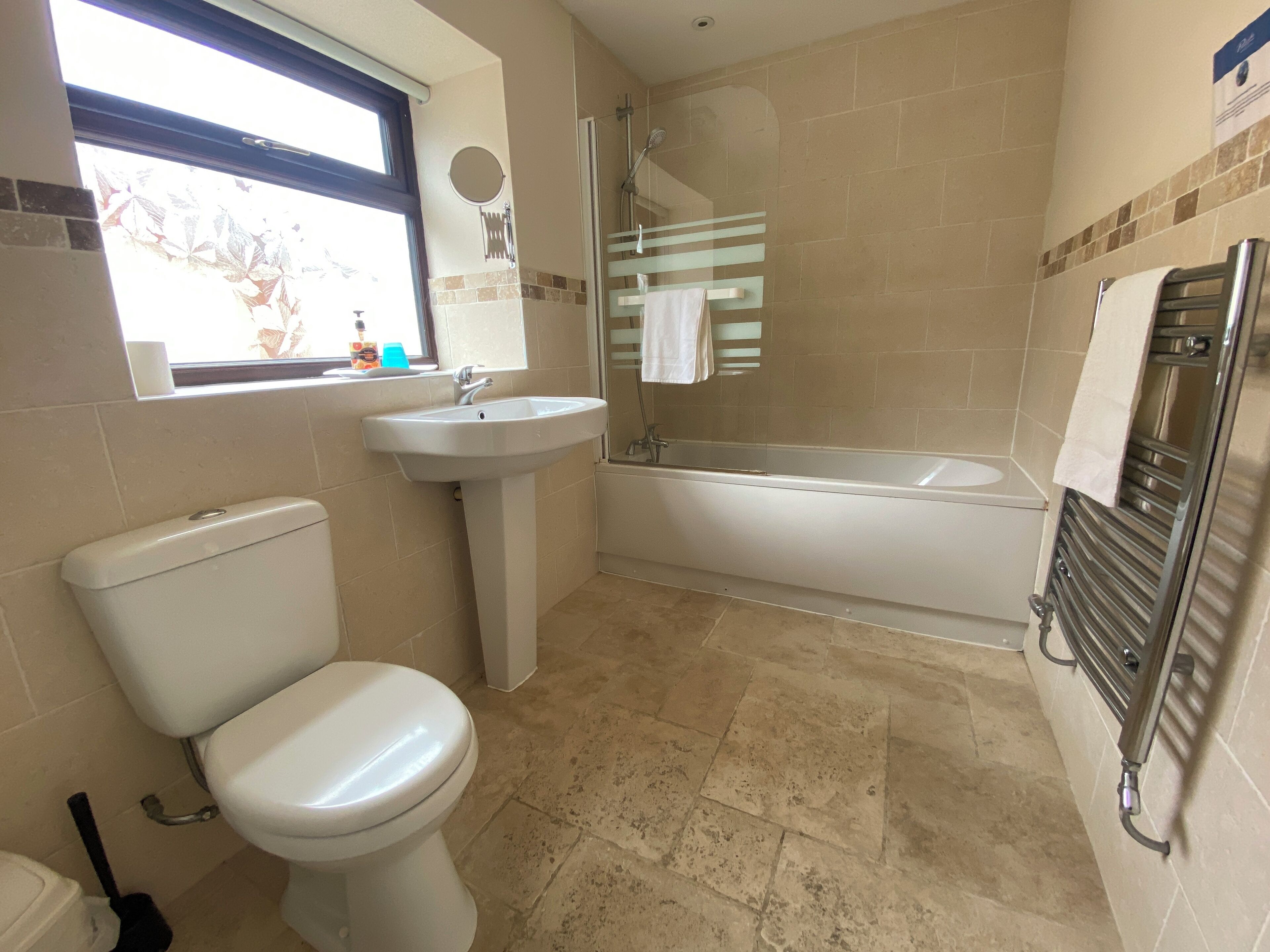 A bathroom with a toilet, sink, and bathtub.