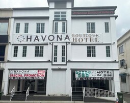 Ein Gebäude mit Schildern für „HAVONA BOUTIQUE HOTEL“ und „BRAND NEW HOTEL DI SINI“, beide mit Kontaktdaten.