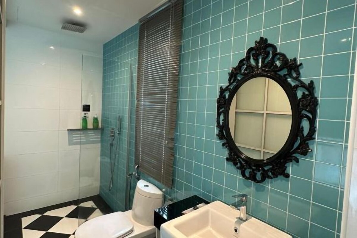 A bathroom with a toilet, sink, and shower.