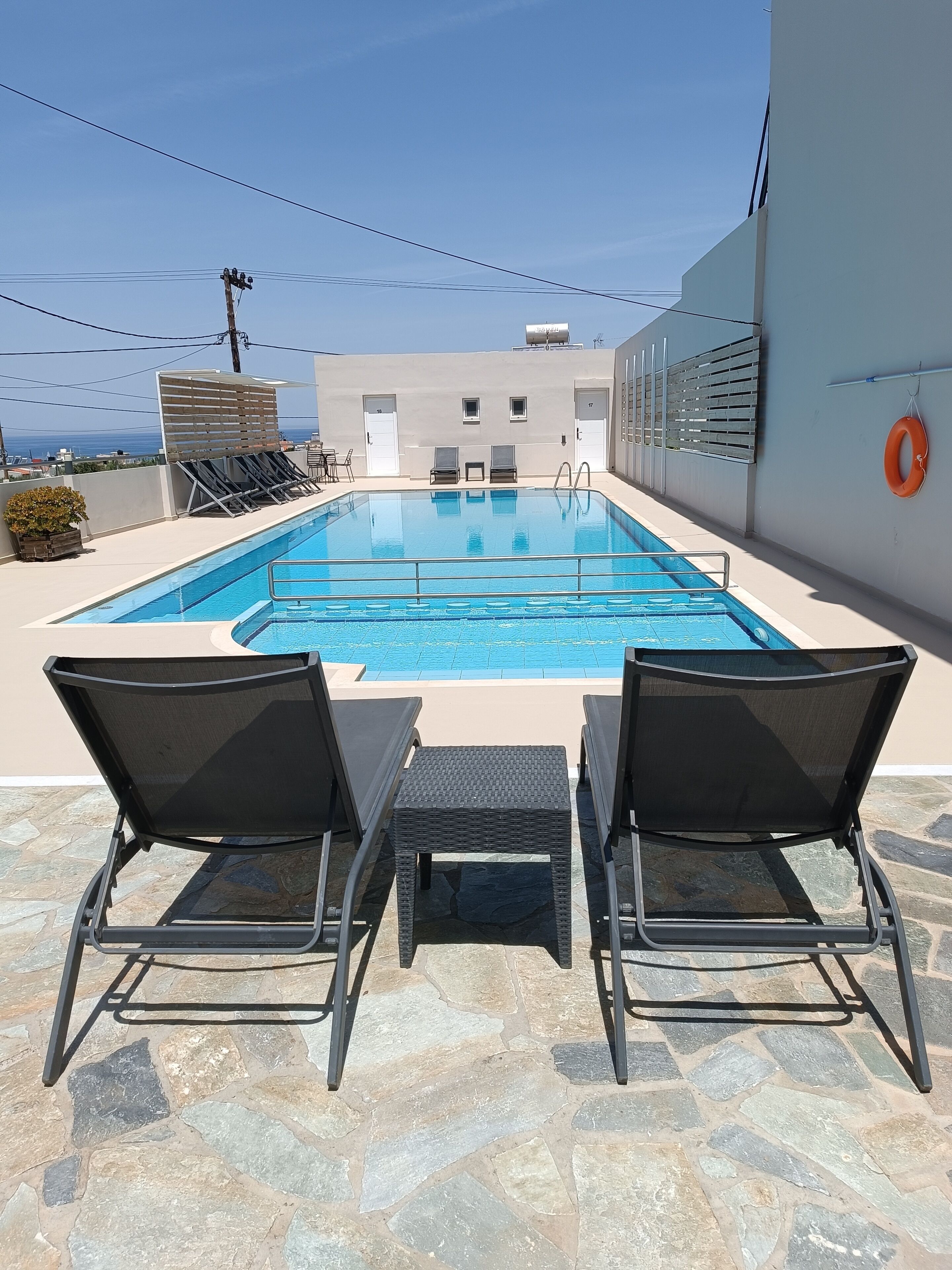 Outdoor pool, open 9:00 AM to 9:00 PM, pool umbrellas, pool loungers