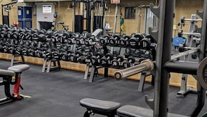 A gym with various weightlifting equipment, including dumbbells and barbells. - Lancaster Hotel (Uxbridge)