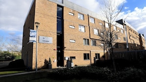 A multi-story brick building with a flat roof, a signboard, and a tree in the foreground. - Lancaster Hotel (Uxbridge)
