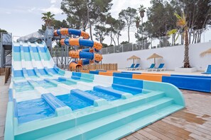 A water park with multiple slides and a pool area.