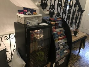 A small refrigerator stocked with beverages and a display of travel guides and books. - Ardenlee Guest House (Edinburgh)