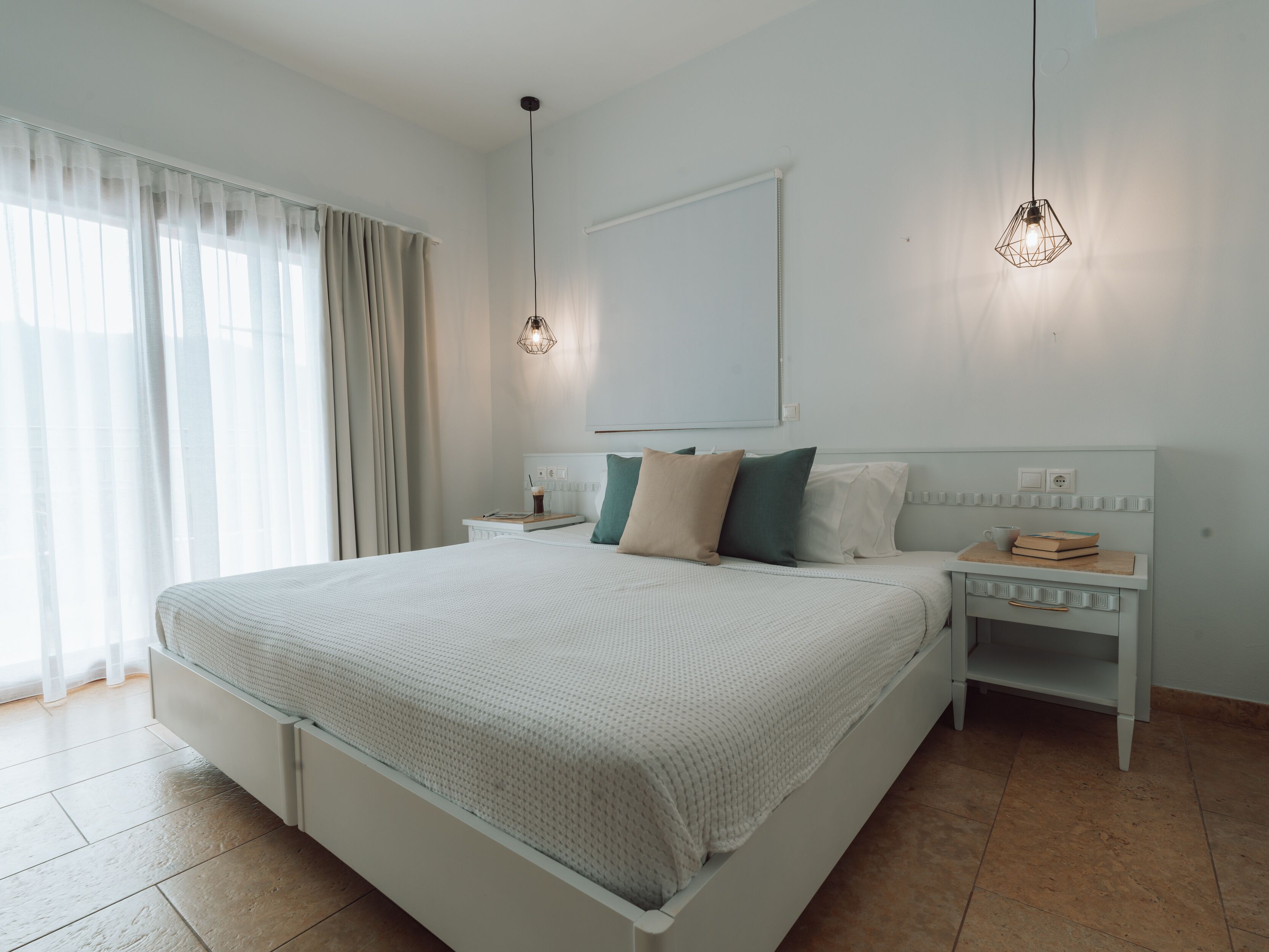 A modern bedroom with a large bed, bedside tables, and a mirror.