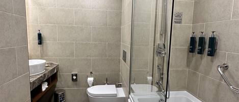 A modern bathroom with a bathtub, toilet, and sink.