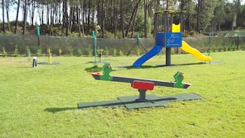 A playground with seesaws, a slide, and a climbing structure.
