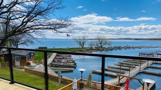 A deck with a view of a marina and docked boats. - Horseshoe Bay Lodge (Walker)