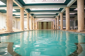 Una piscina techada, sillones reclinables de piscina