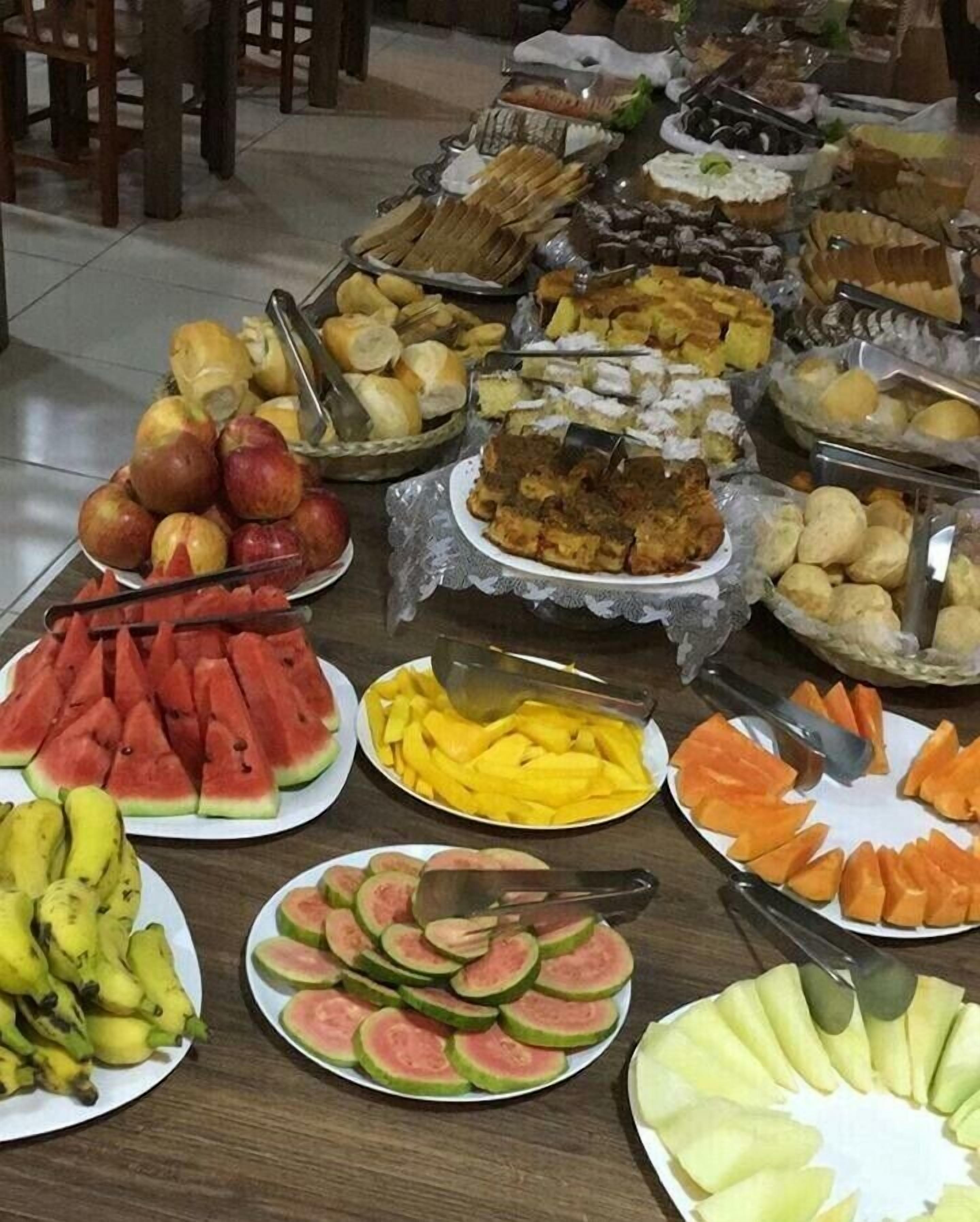 Una mesa de buffet con diversas frutas y platos.