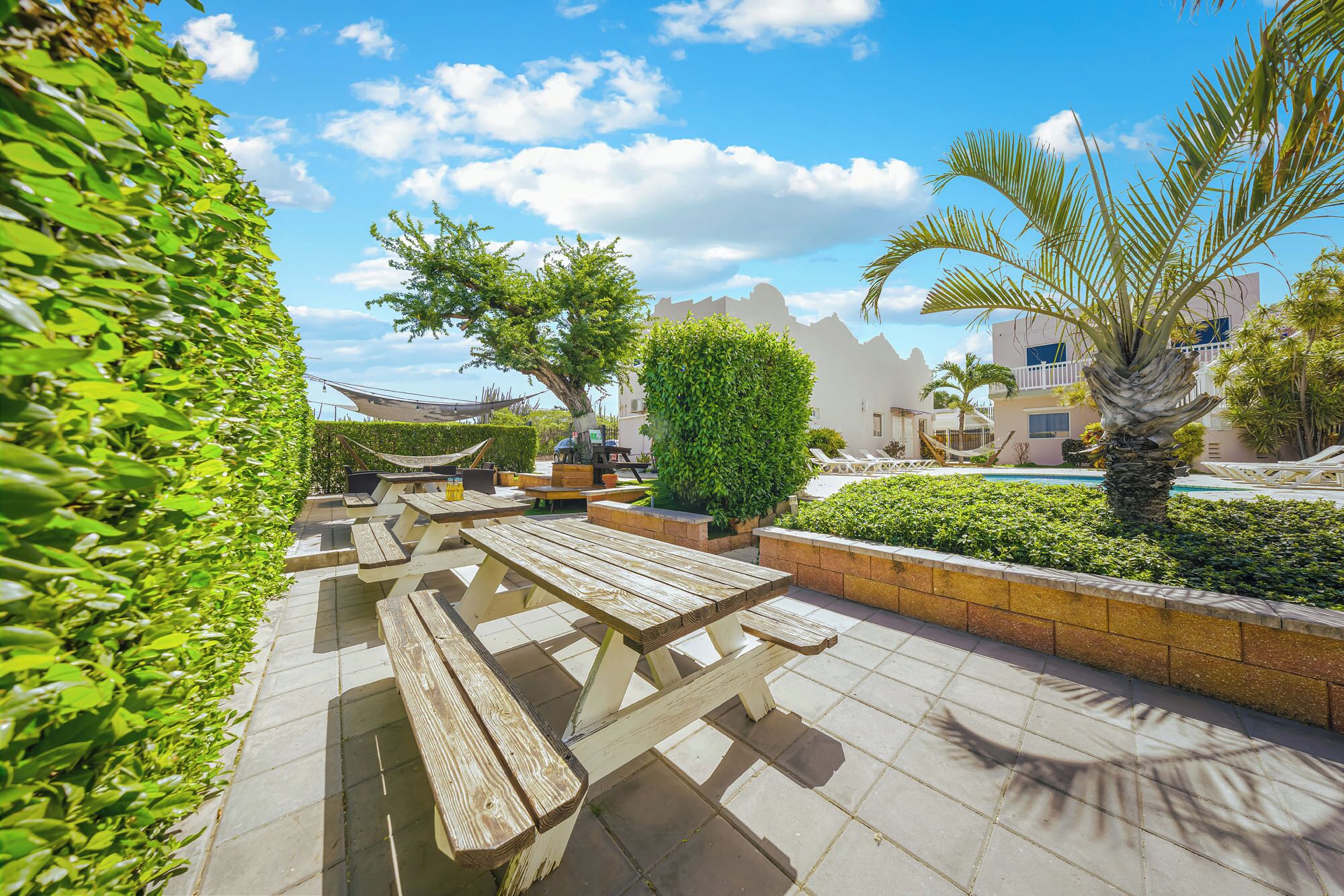 A patio area with picnic tables and a pool.