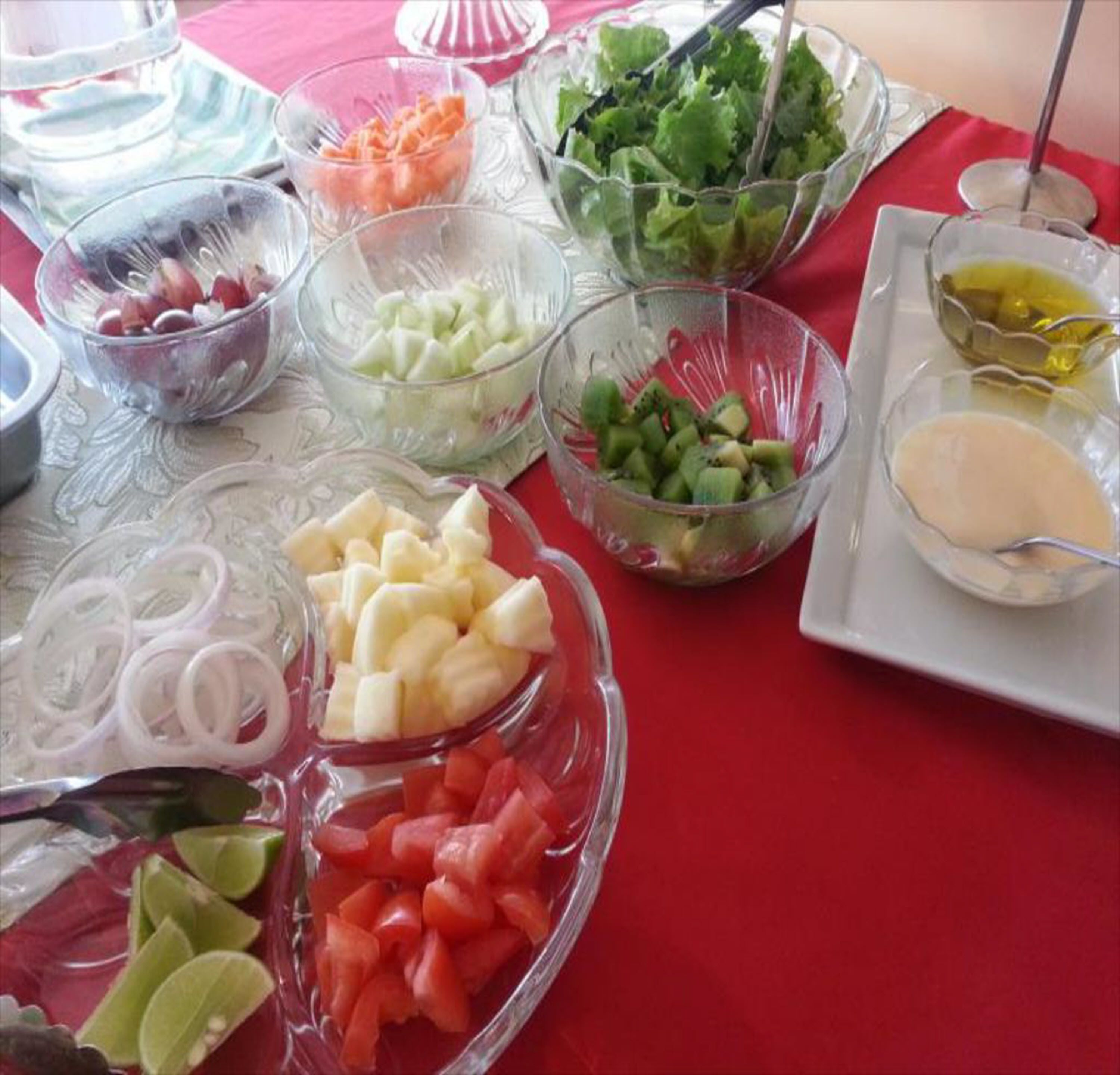 A table with various food items including fruits, vegetables, and condiments.