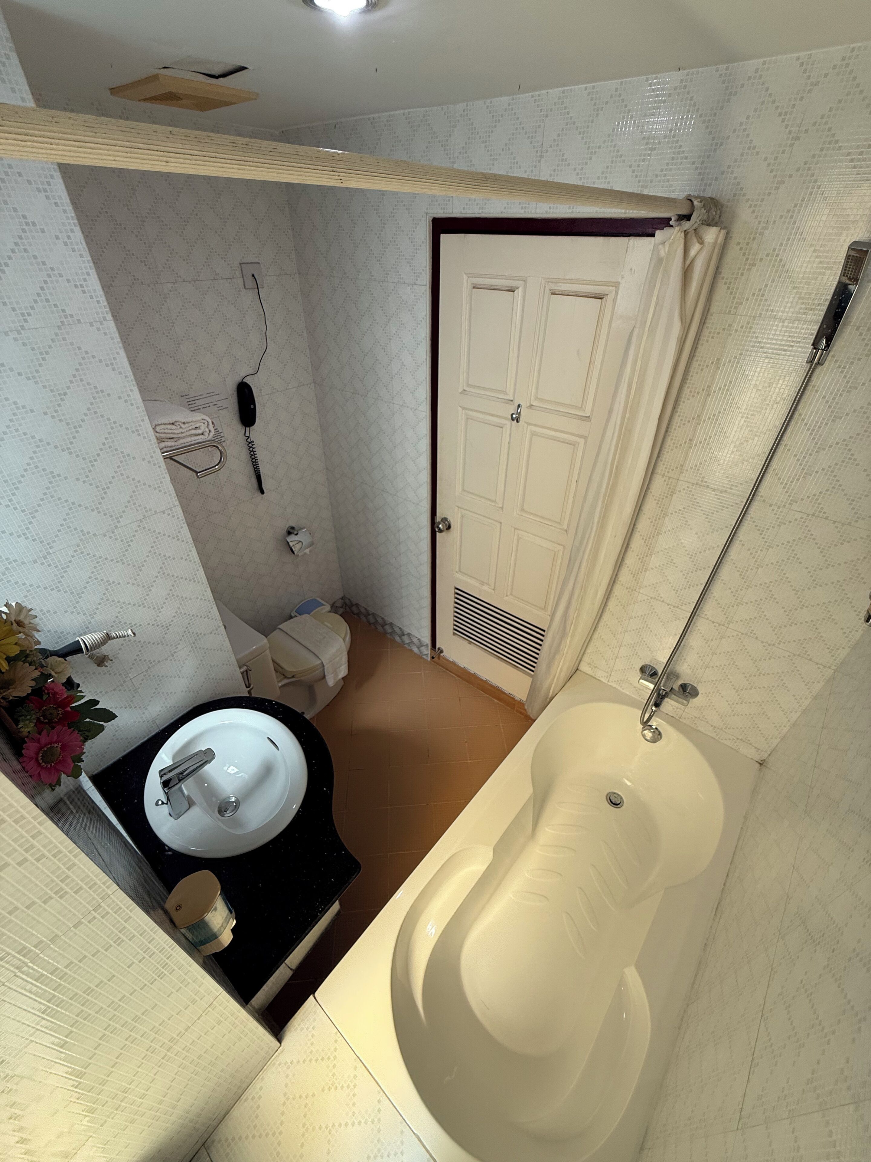 A bathroom with a bathtub, a sink, a toilet, and a shower.