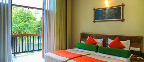 A hotel room with two beds, a balcony, a painting on the wall, and a nightstand with a phone.