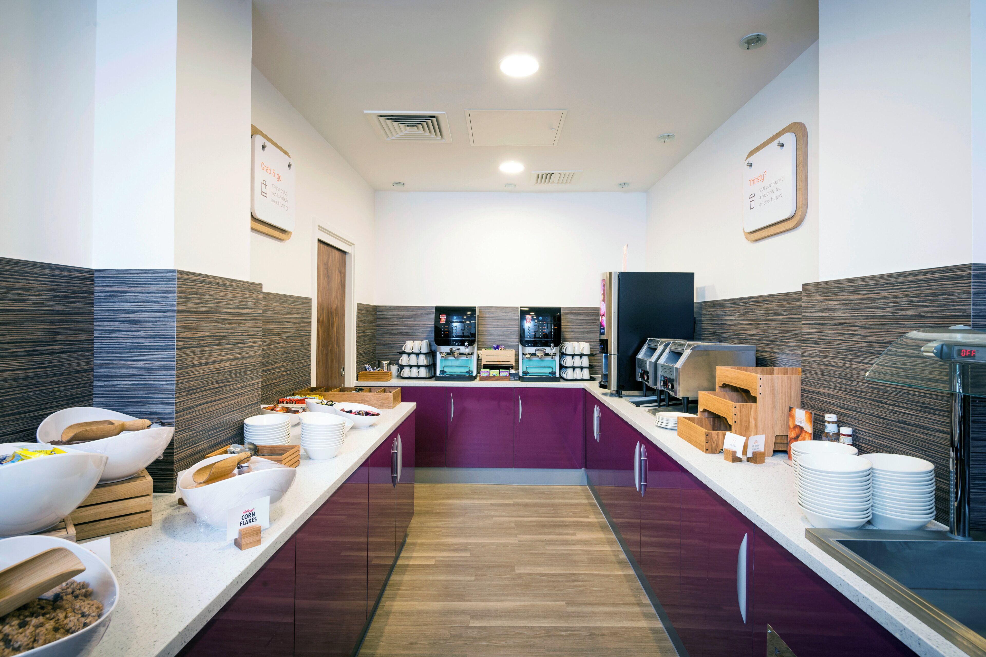 A buffet area with a variety of food items and a coffee station.