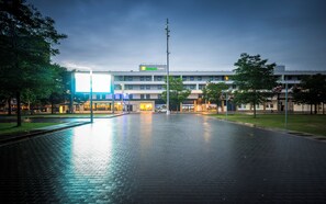 A spacious, modern hotel with a brick-paved courtyard, a large illuminated sign, and a clear view of the building's entrance. - Holiday Inn Express Middlesbrough - Centre Square by IHG (Middlesbrough)