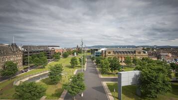 A campus with multiple buildings, a central open space, and a large parking area.