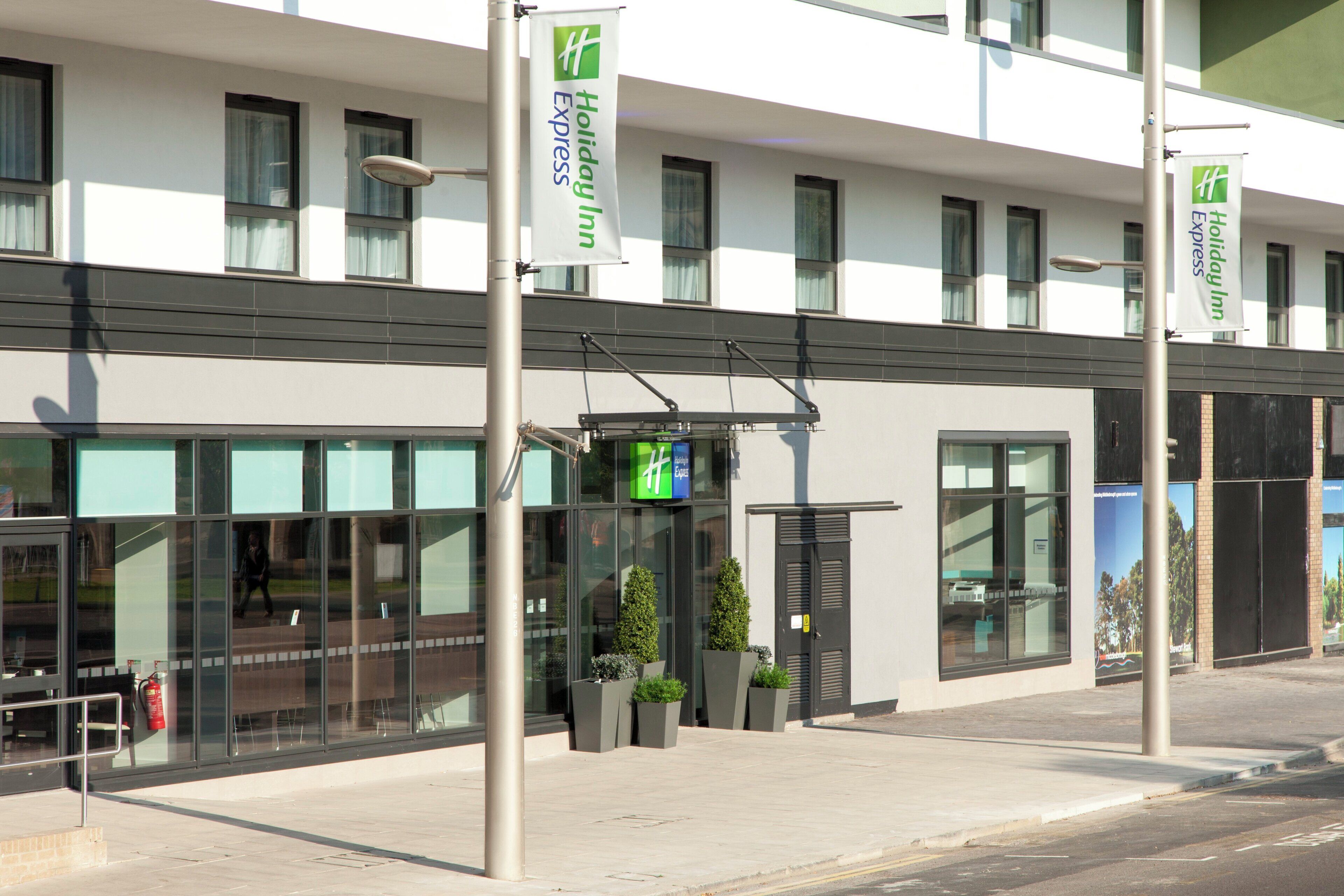 A modern building with a Holiday Inn Express sign, large windows, and a clean, contemporary design.