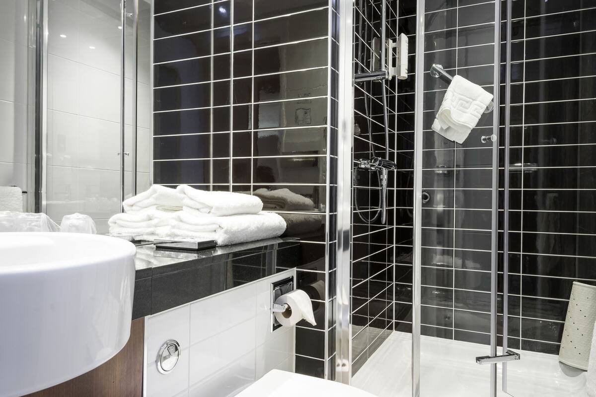 standard room | bathroom | shower, hair dryer, towels, soap