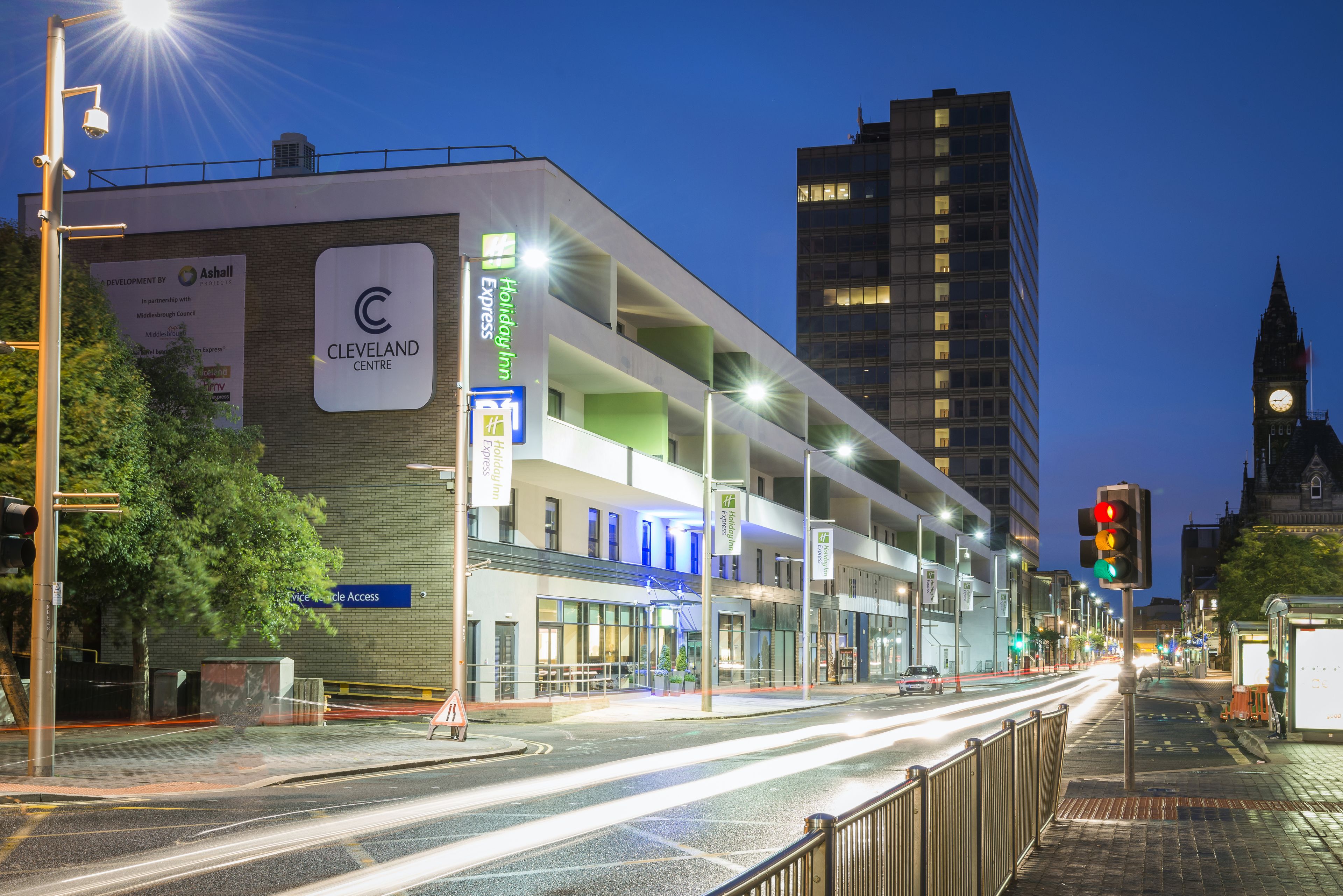 A multi-story hotel with a prominent 'Cleveland Centre' sign, a Holiday Inn Express, and a clock tower in the background.
