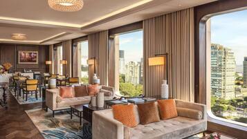 A modern hotel lobby with a dining area, large windows, and a city view.